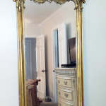 Refinishing antique gilded carved mirror before
